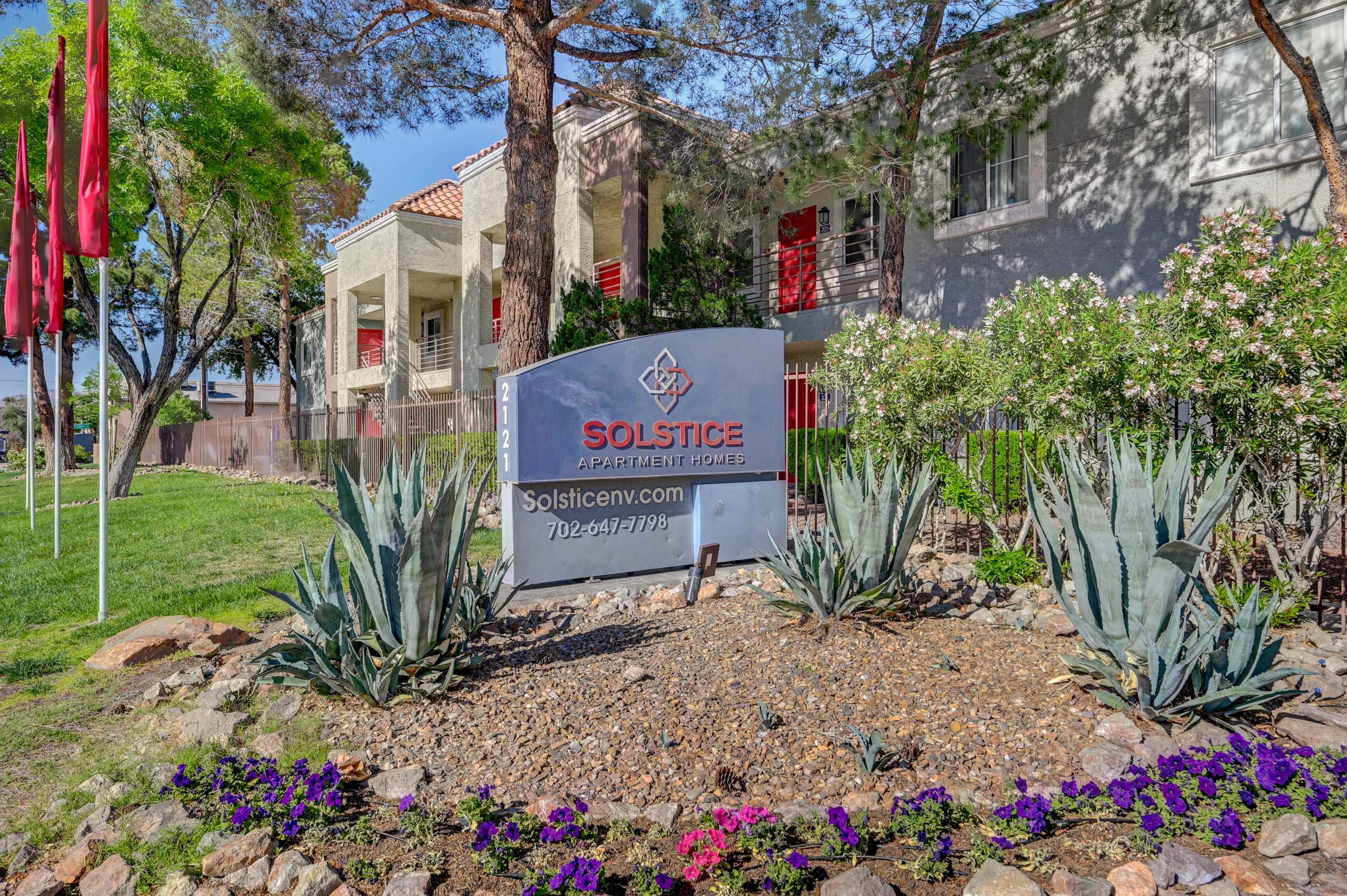 Solstice Apartments entrance sign with flowers